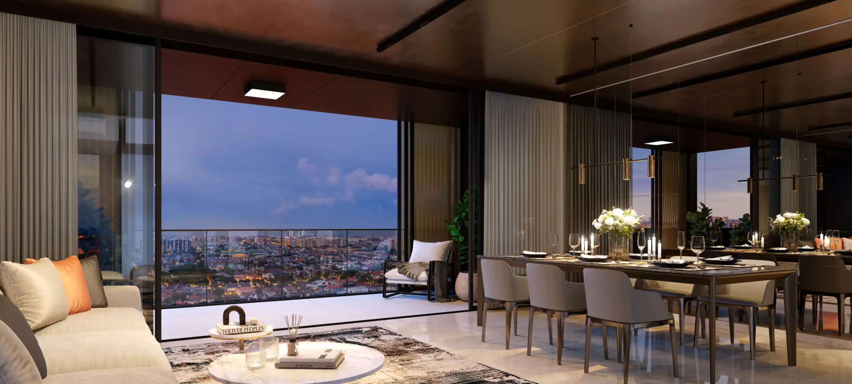 A luxurious dining and living room with a warm ambiance, featuring a comfortable beige sofa with orange pillows, a stylish coffee table, and a spacious dining table set for an elegant meal. The room opens to a large glass balcony with an expansive view of the city skyline at dusk.